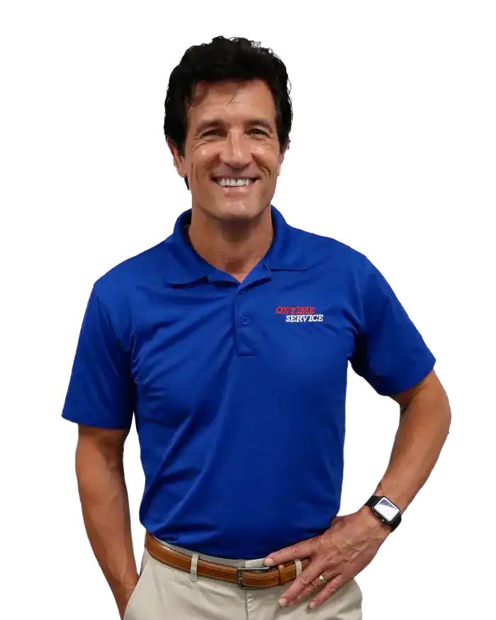 Man wearing a blue polo shirt with “Certified Service” text, khaki pants, and a smartwatch, standing and smiling against a plain white background.